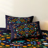 A dark blue duvet cover featuring a colorful print of flowers and butterflies.
