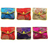 A set of five multi-color silk brocade jewelry pouches in various floral patterns and colors.