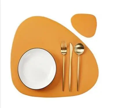 A set of reusable vinyl placemats in orange and yellow featuring a white plate and silverware.