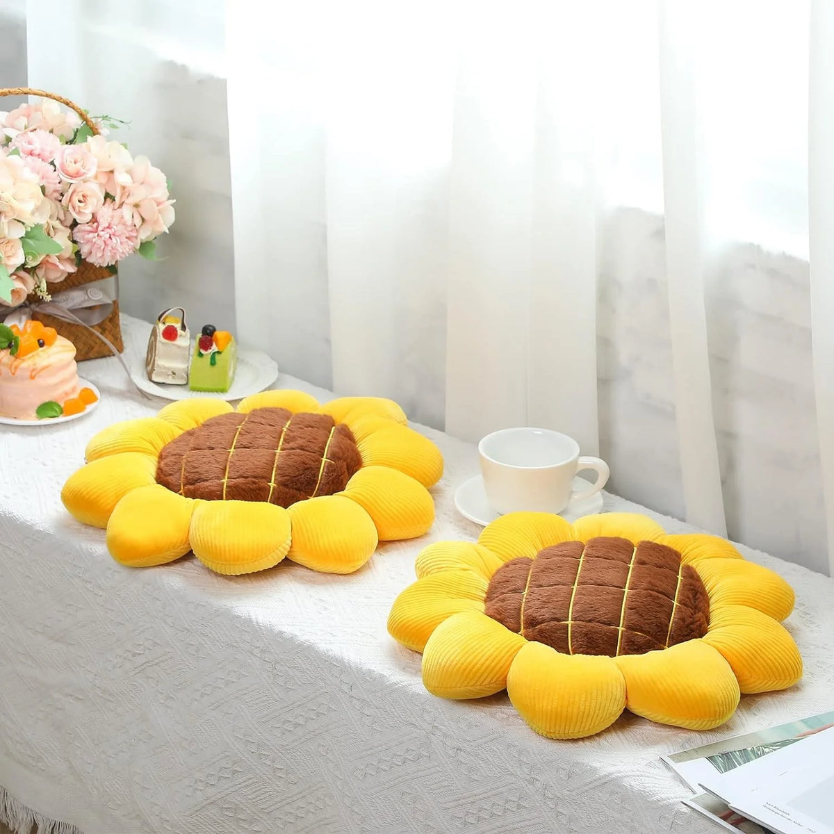 A collection of yellow sunflower shaped throw pillows displayed on a white surface.