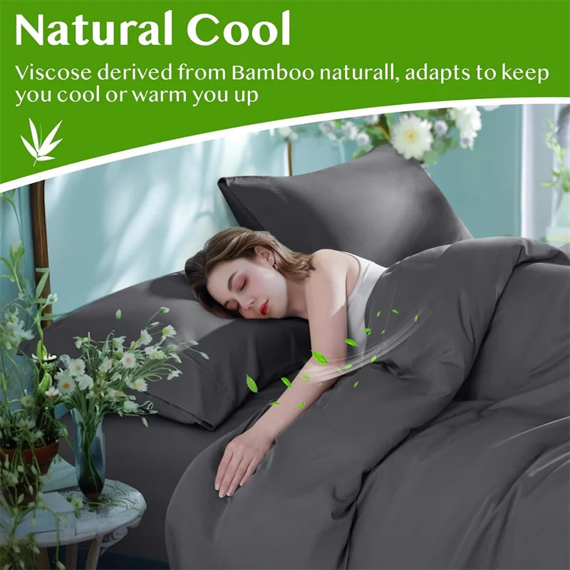 A woman is relaxing on a bed covered with a dark gray duvet, demonstrating the natural cool properties of bamboo fabric.