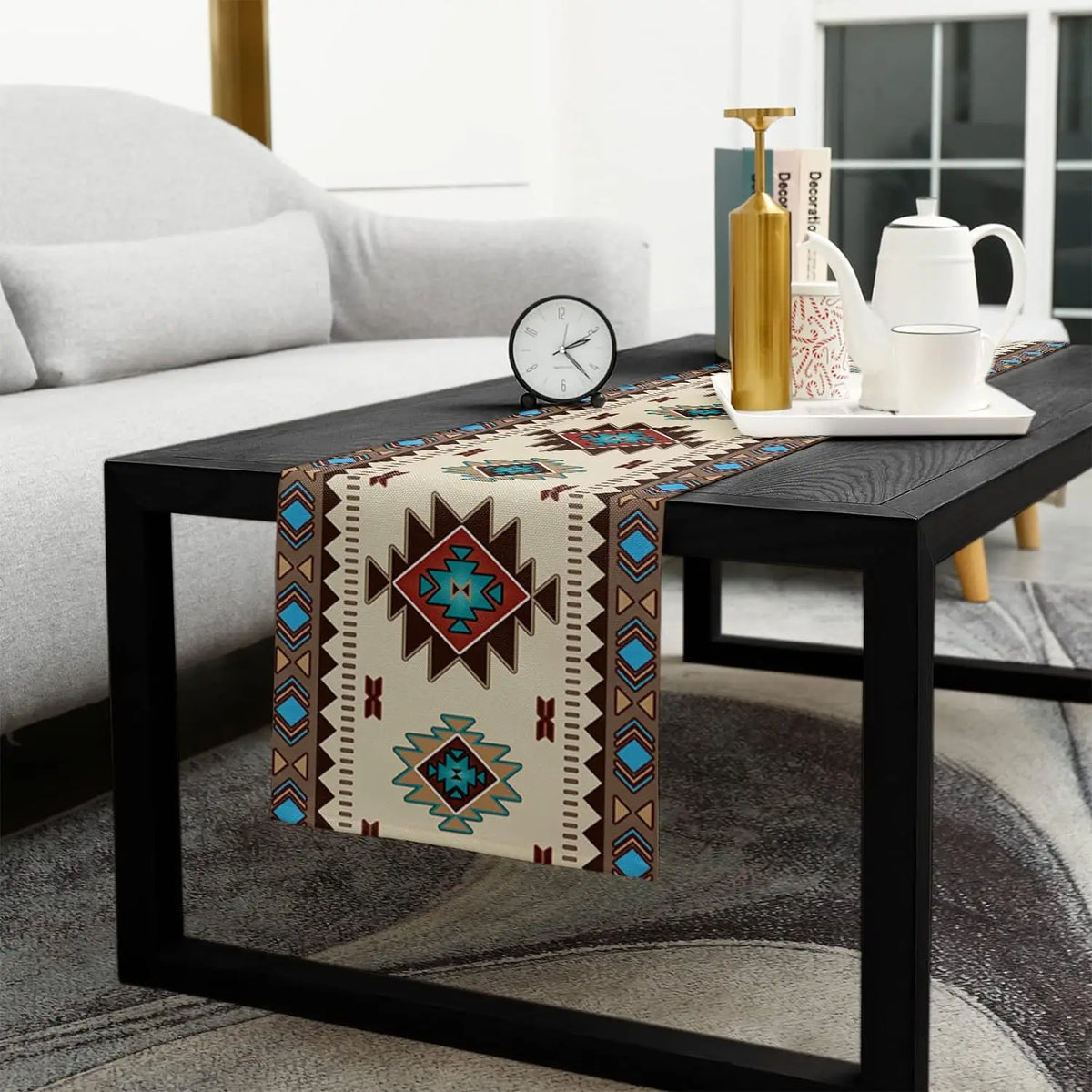 A bohemian linen table runner with an Indian-inspired geometric print displayed on a black table.
