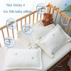 White ice silk baby pillow with a teddy bear, designed to be not sticky and breathable for sleep.
