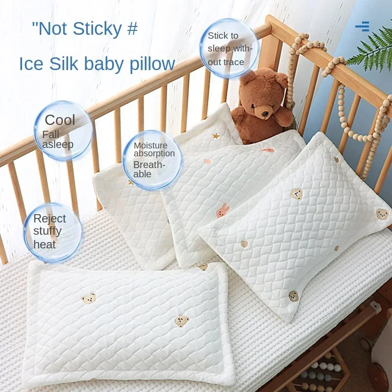 White ice silk baby pillow with a teddy bear, designed to be not sticky and breathable for sleep.