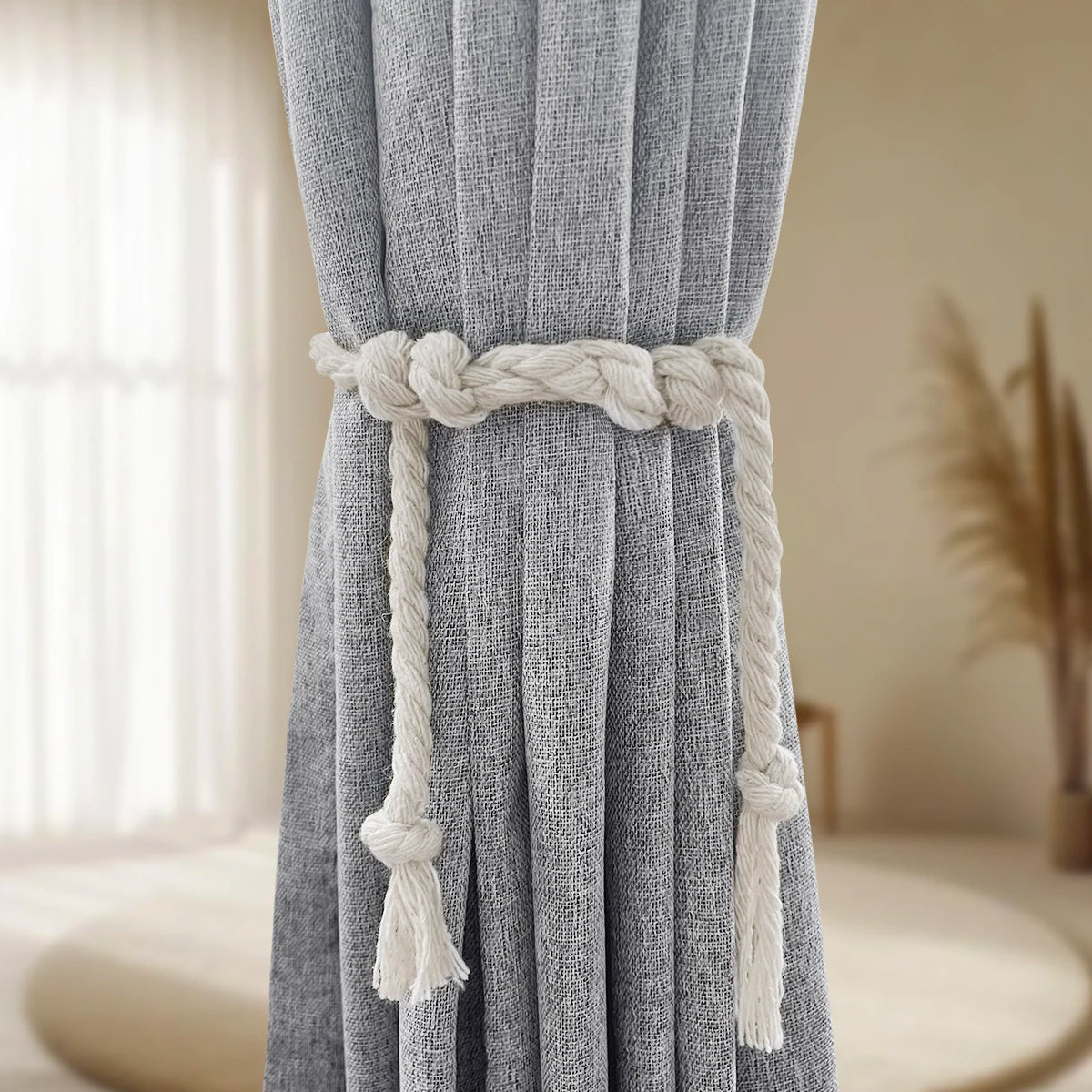 Gray linen curtain with a natural rope tie gathered at the top