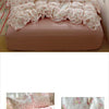 A pink floral bedding set featuring a duvet, pillows, and decorative fabric on a bed.