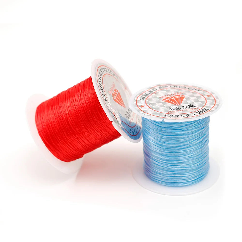 Spools of multicolor elastic beading cord, showing red and blue strands.