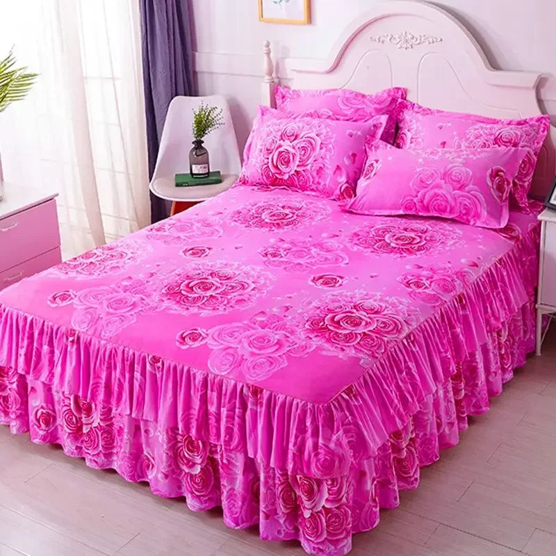 Pink fitted bed sheets with elastic lace trim displayed on a bed.