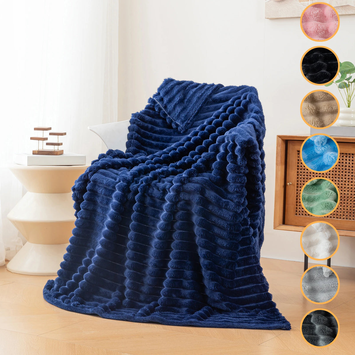 A deep blue fluffy flannel throw blanket draped over a chair in a bright room.