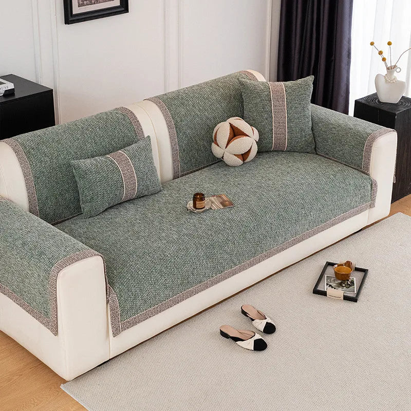 A light gray sofa cushion cover with a textured fabric and striped trim sits on a beige rug.