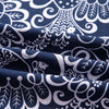 Close-up of dark blue and white bohemian printed linen fabric showing intricate floral and leaf patterns.