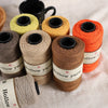 A collection of five spools of Hollow yarn in various shades of yellow and orange for knitting and crochet projects.