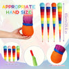 A hand holds an orange rainbow comet ball with a soft tail, shown alongside various colored cones.
