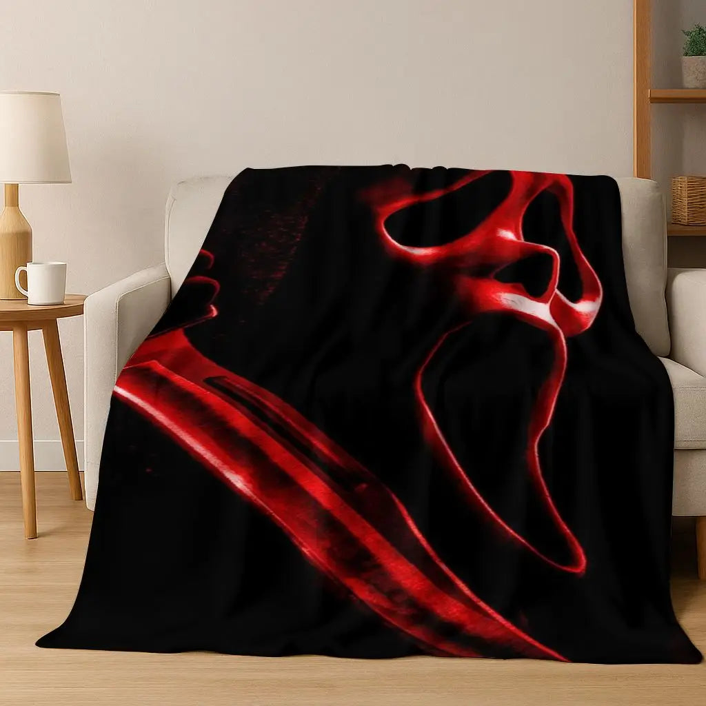 A dark red, stylized horror character design printed on a black flannel throw blanket.