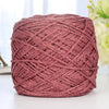 A ball of metallic pink silk yarn used for crocheting and knitting
