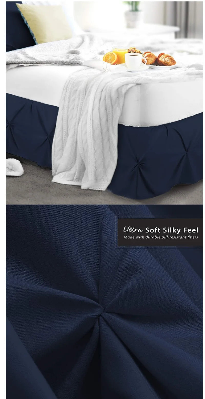 Navy blue premium wrap-around bed skirt with white throw blanket on a bed.
