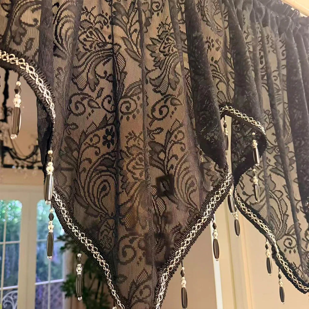 Elegant black lace curtain valance featuring intricate floral patterns and silver trim.