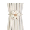 A set of two magnetic floral curtain tiebacks with beige petals and twine, displayed against a background of white fabric.