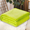 A bright lime green cozy coral fleece throw blanket folded neatly on a white fluffy surface.