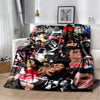 A retro printed flannel throw blanket featuring a collage of diverse faces and vibrant colors.