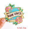 Colorful embroidered book lover letter patch with pink and teal floral accents