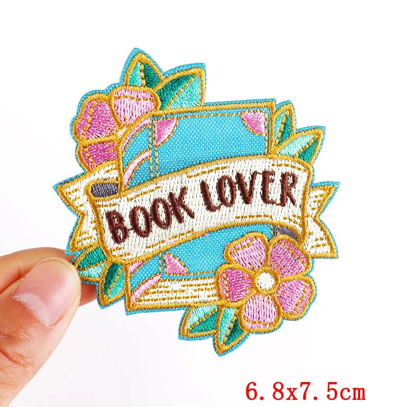 Pink letter embroidered iron-on patch with a banner design for book lovers