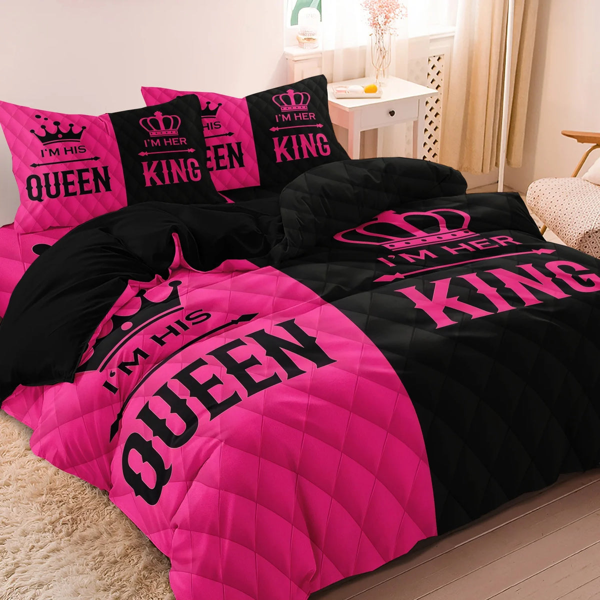 A couple duvet set featuring pink and black crown print microfiber bedding with pillows.