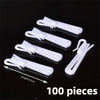 A set of 100 white adjustable curtain hanging hooks shown arranged on a black surface.
