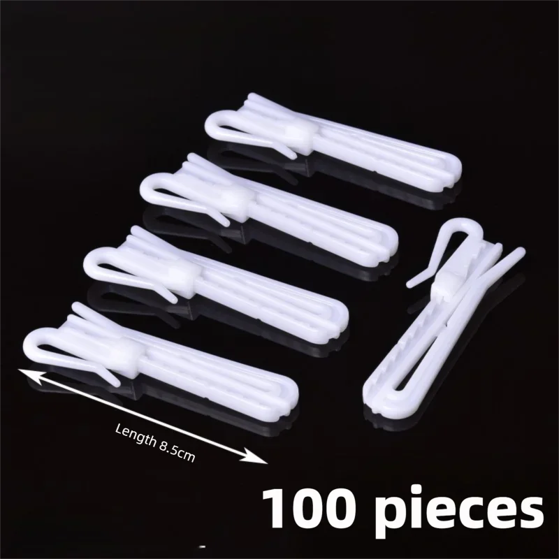 A set of 100 white adjustable curtain hanging hooks shown arranged on a black surface.