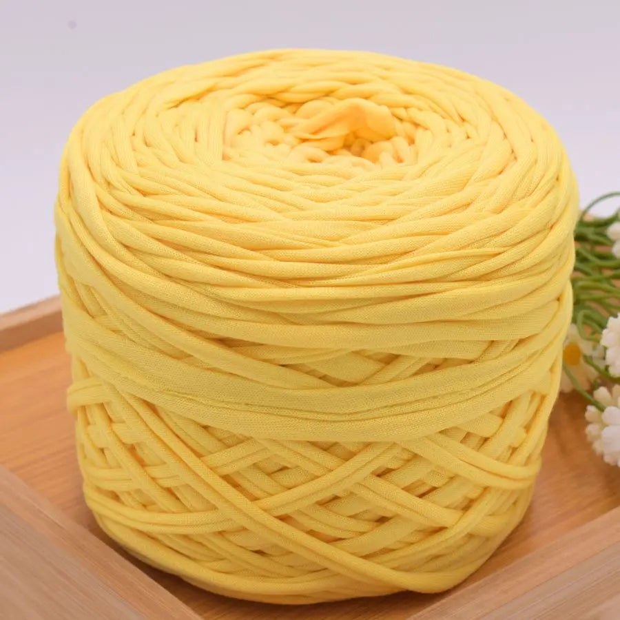 A ball of bright yellow craft yarn made of 100% polyester for knitting and DIY projects.