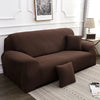 A dark brown elegant faux silk sofa cover placed on a light rug in a well-lit room.