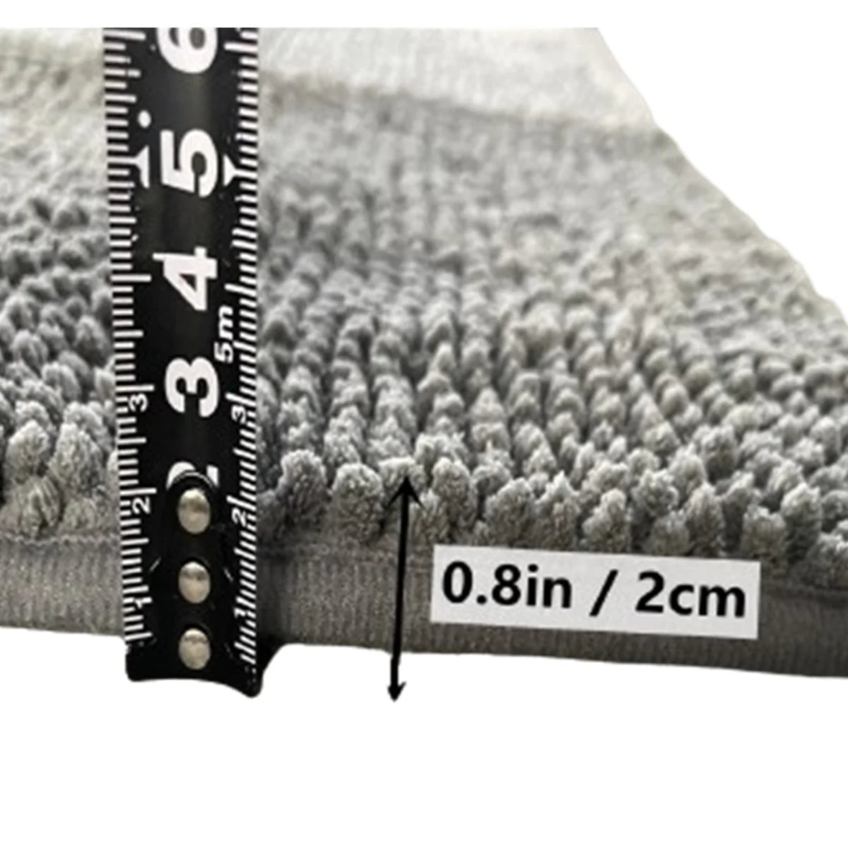 Close-up of a gray chenille pet door mat showing a ruler for scale and a measurement of 0.8in / 2cm.