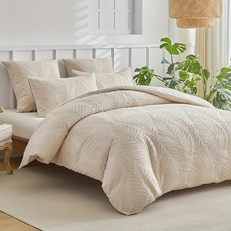 A beige embossed leaf duvet cover set displayed on a bed with white bedding and natural light.