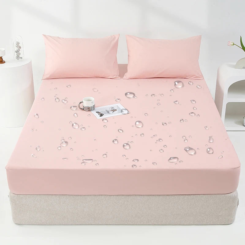 A pink waterproof mattress and bed protector sheet is laid out on a mattress with water droplet designs.