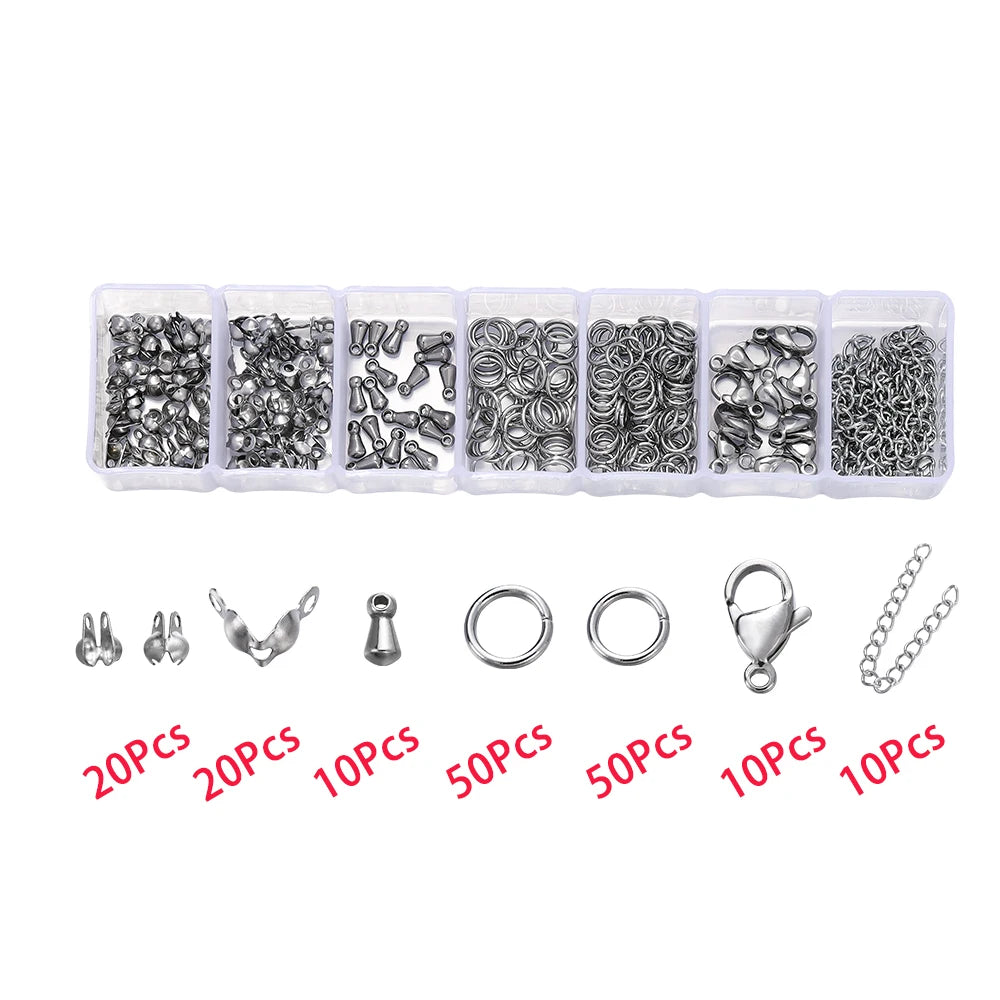A collection of silver lobster clasp findings and jewelry components packaged in small plastic compartments.