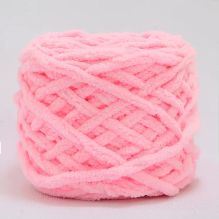 A ball of bright pink soft chenille knitting yarn for hand crafting.