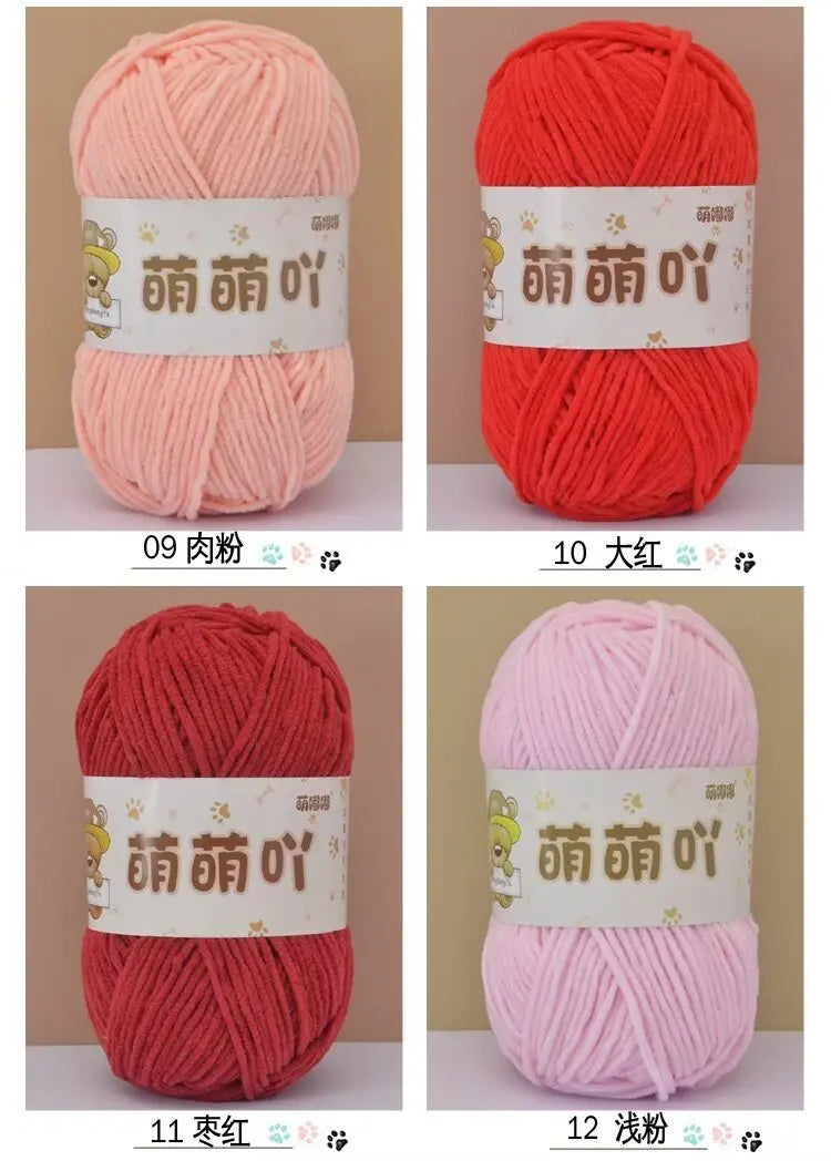 A set of twelve skeins of soft bulky chenille yarn in various colors including pink, red, and light pink, packaged with label