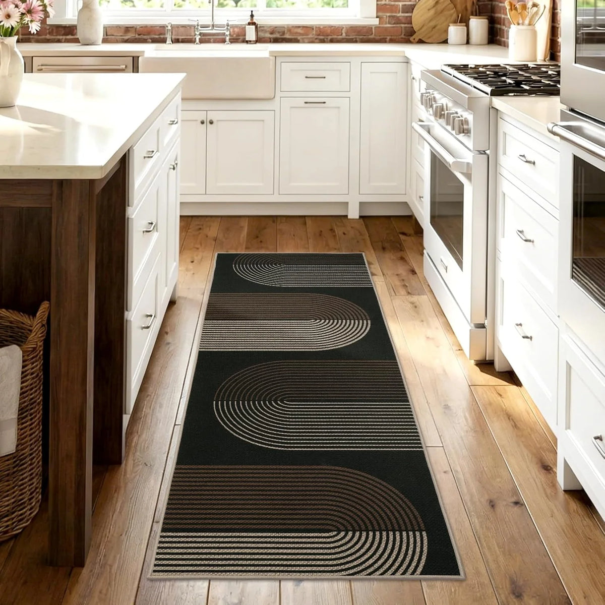 A long runner rug with geometric lines in black and tan tones placed on a light wood floor.