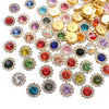 A close-up view of various colorful crystal rhinestone sew-on buttons in gold and silver tones.