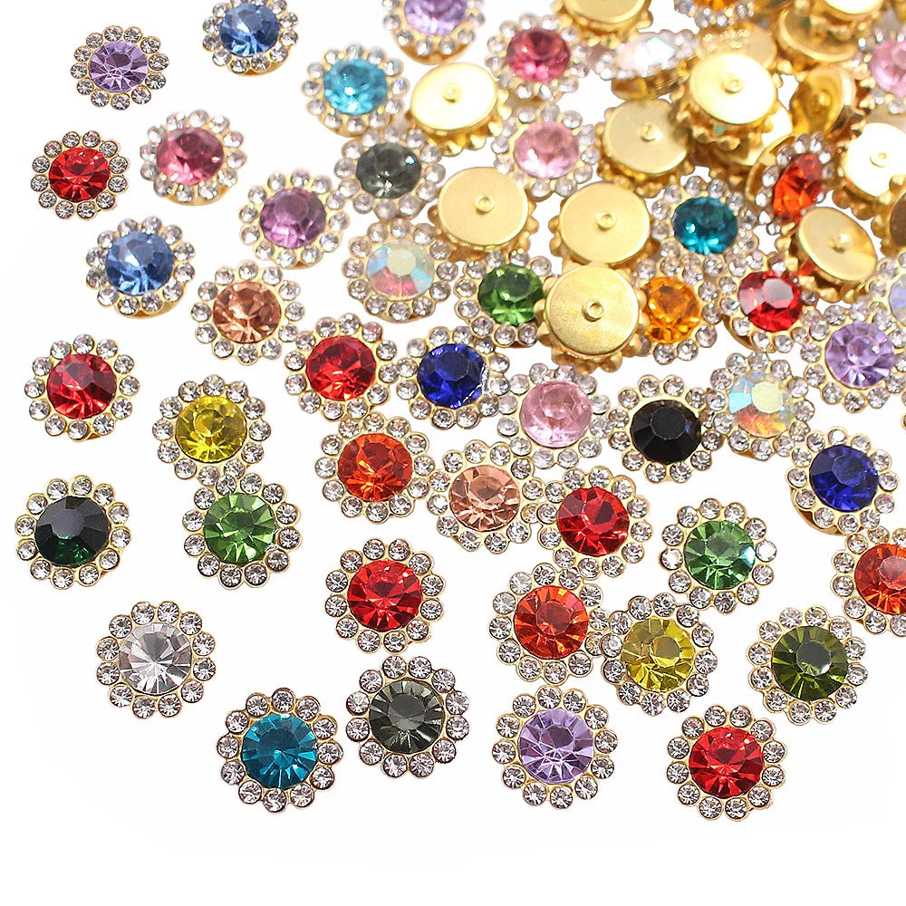 A close-up view of various colorful crystal rhinestone sew-on buttons in gold and silver tones.