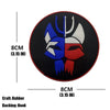 Black rubber armband patch featuring a stylized eagle head design in blue and white.