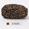 A ball of hand-dyed fabric strip yarn featuring a leopard print pattern.