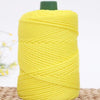 A spool of bright yellow crochet ice rope with a green cap, ready for DIY crafts.