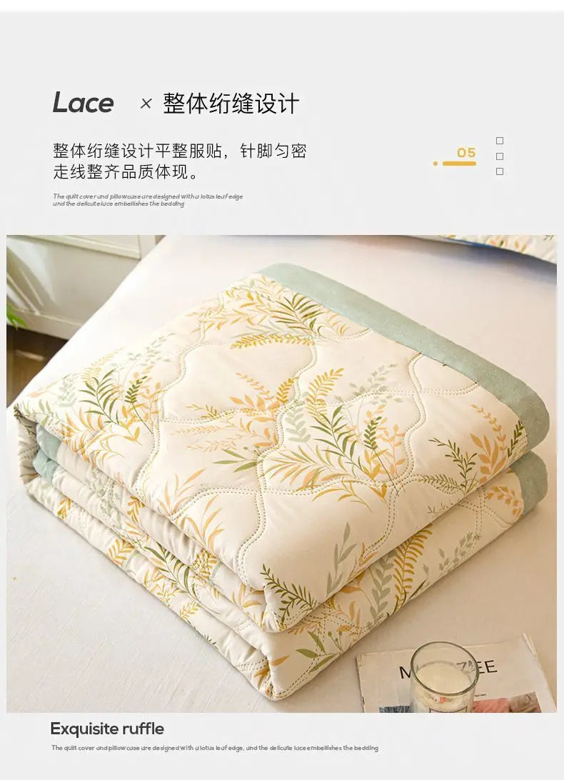 A stack of white and green quilted fabric covers showcasing lace embroidery for a soft breathable quilt.