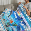 A person is holding a bright blue Frutiger Aero art throw blanket featuring digital and nature themes.