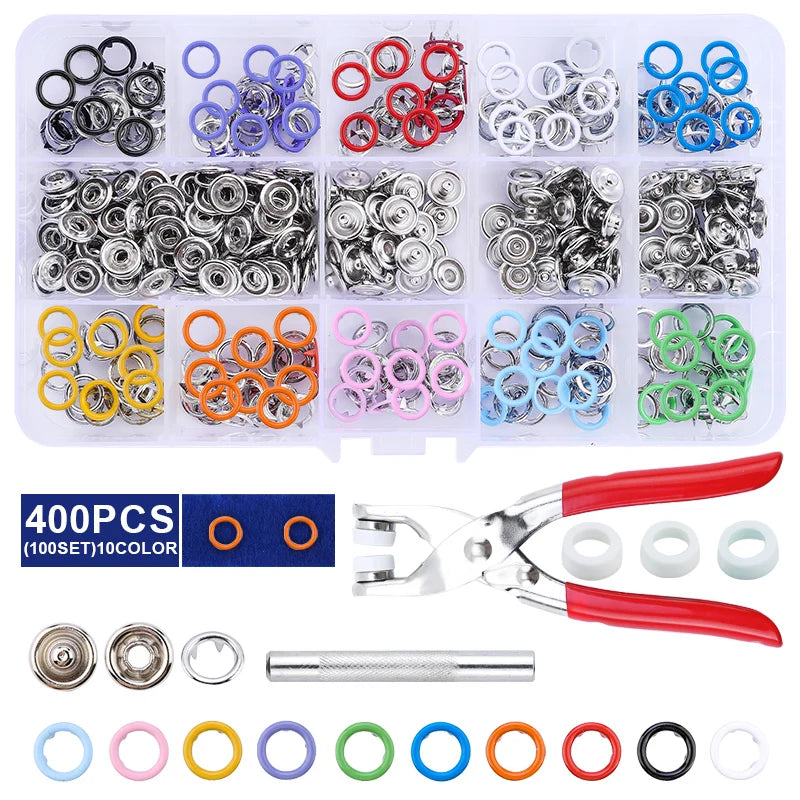 A variety of heavy duty metal snap fasteners, rings, and tools are displayed in a clear plastic container.