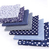 A collection of fabric squares featuring various patterns including floral, dot, plaid, and star prints.