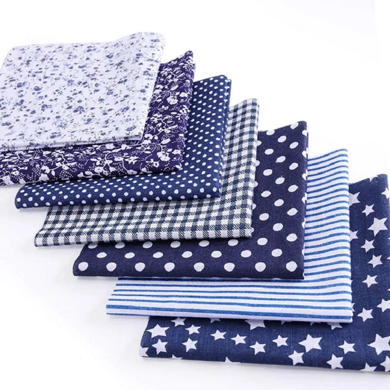 A collection of fabric squares featuring various patterns including floral, dot, plaid, and star prints.