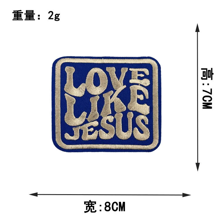 A dark blue embroidered patch with the text LOVE LIKE JESUS in gold thread.