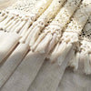Cream geometric lace short curtains with tasseled fringes draped on fabric